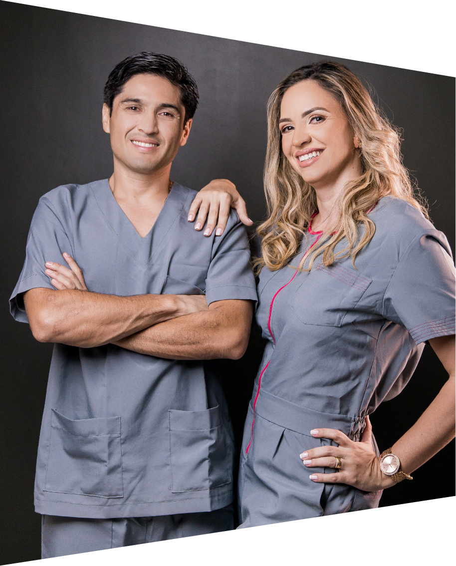 Man and woman wearing scrubs and smiling