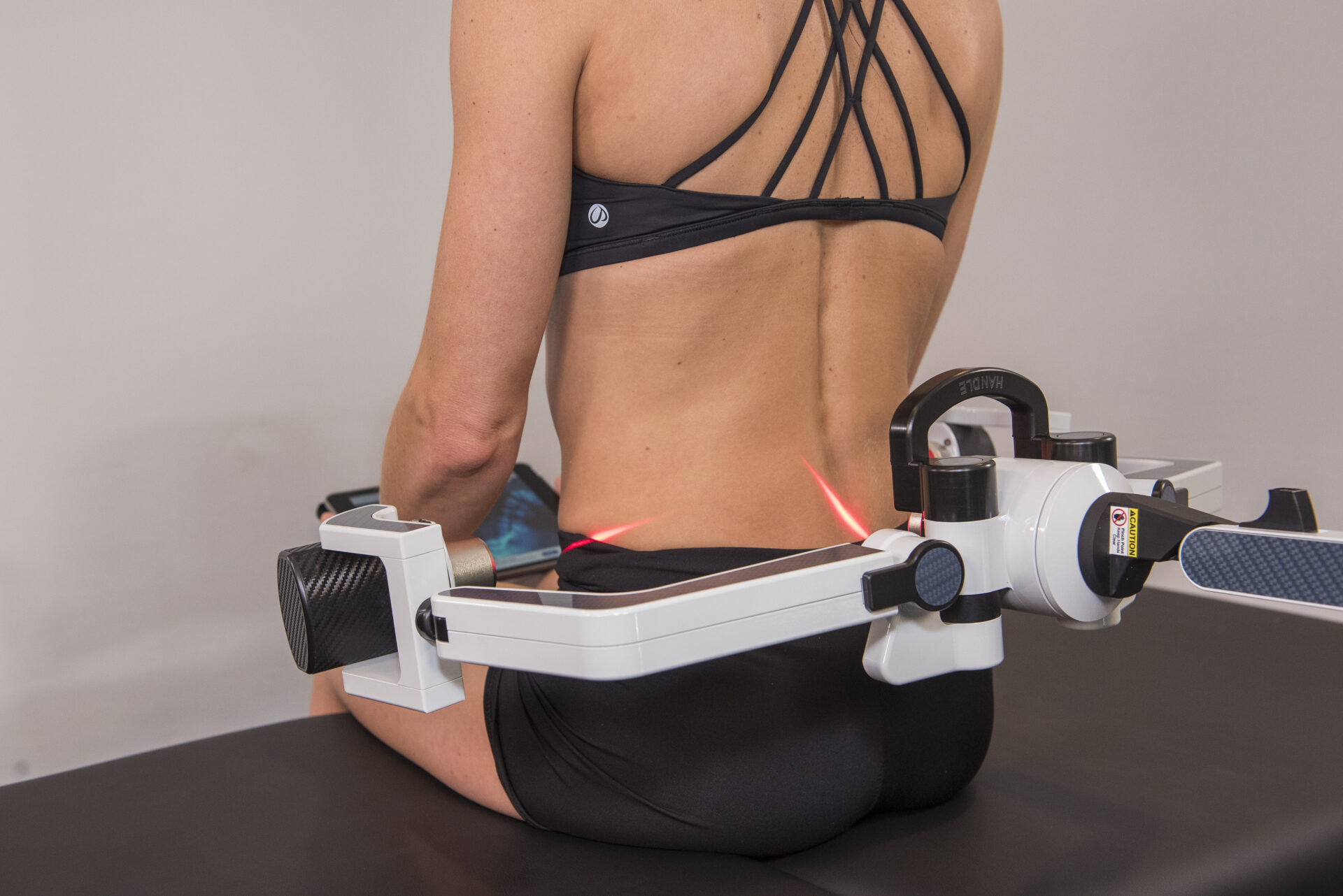 FX 635 laser being used on a woman's back