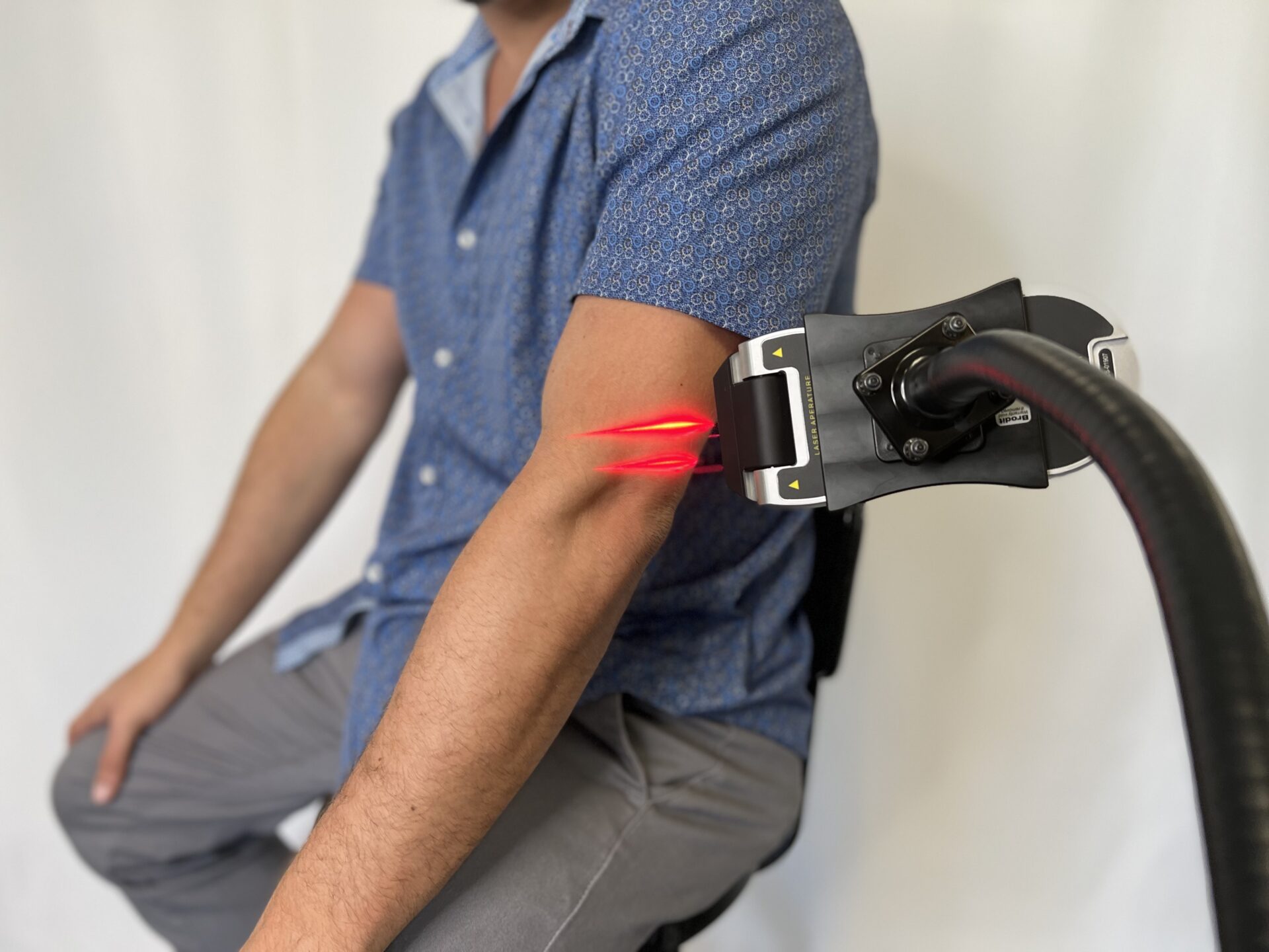 Laser being used in stand to treat elbow