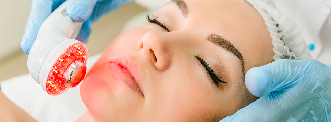Woman receiving non-invasive Erchonia laser facial treatment