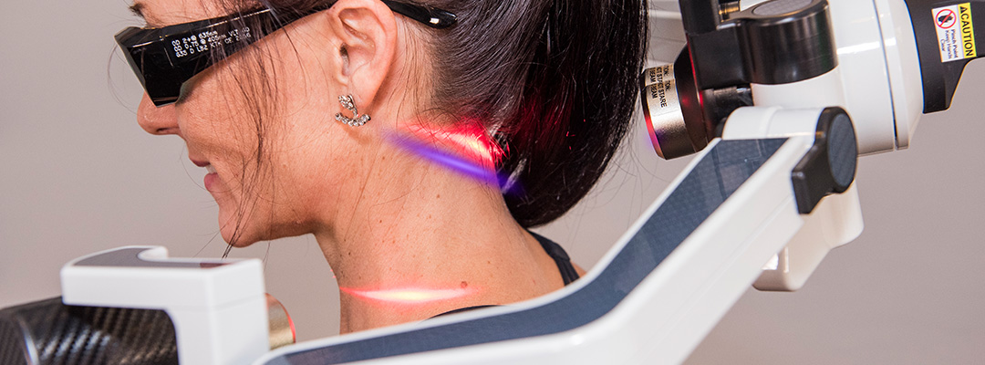 Woman gets Low Level Laser Therapy on her neck.