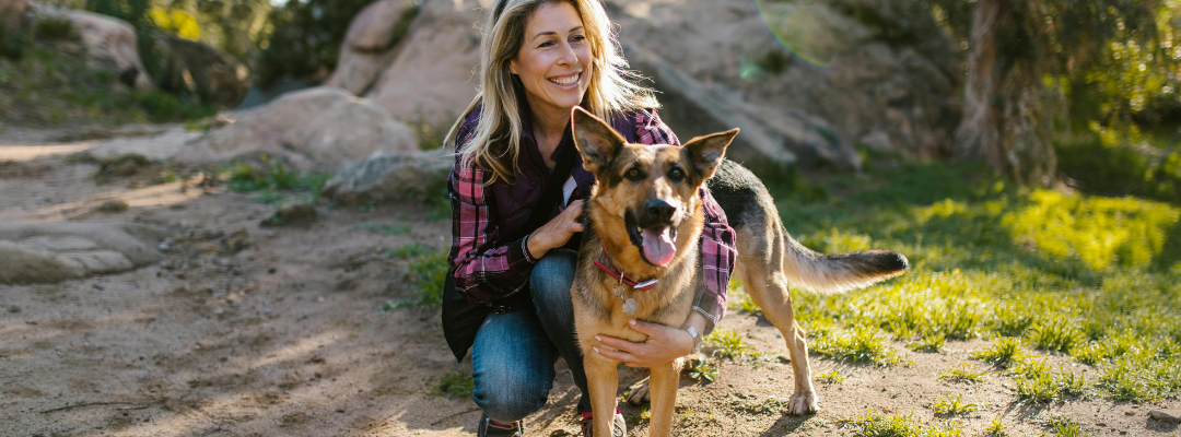 Woman and German Shepherd on Hike