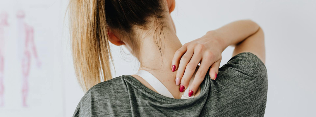 Woman Grabbing Neck and Shoulder in Pain
