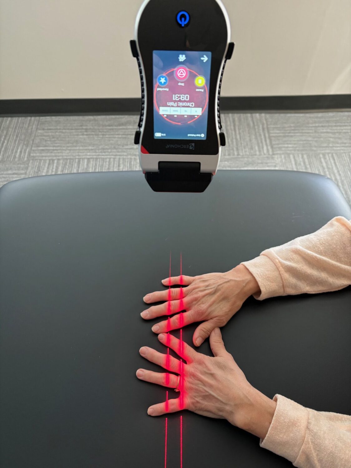 An XLR8 laser applied to a patient’s hands