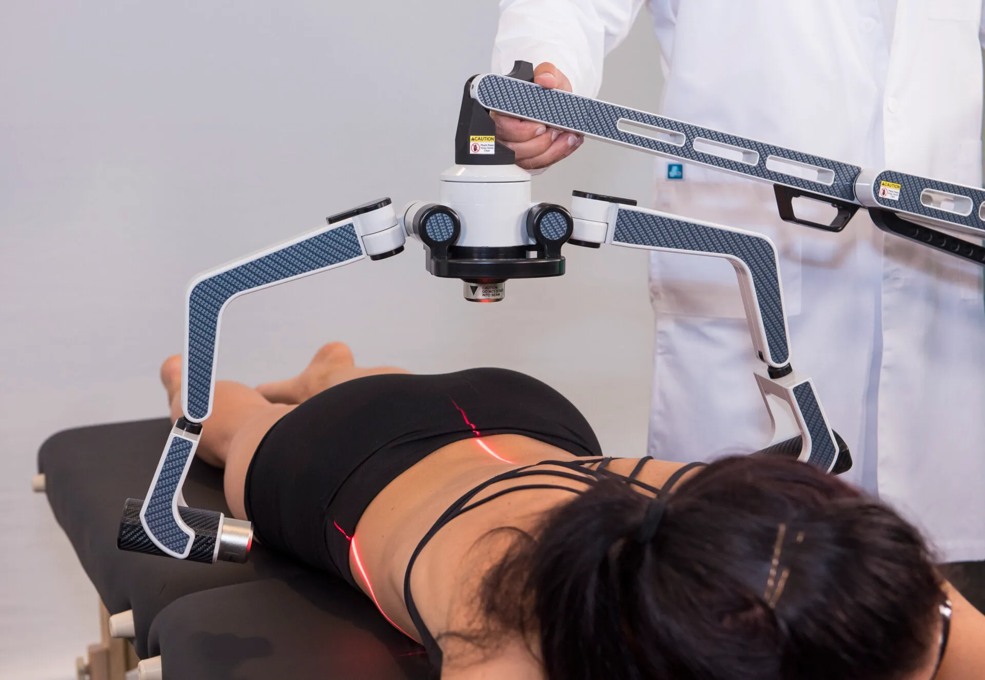 A patient lying on a treatment table beneath an FX 635 scanner