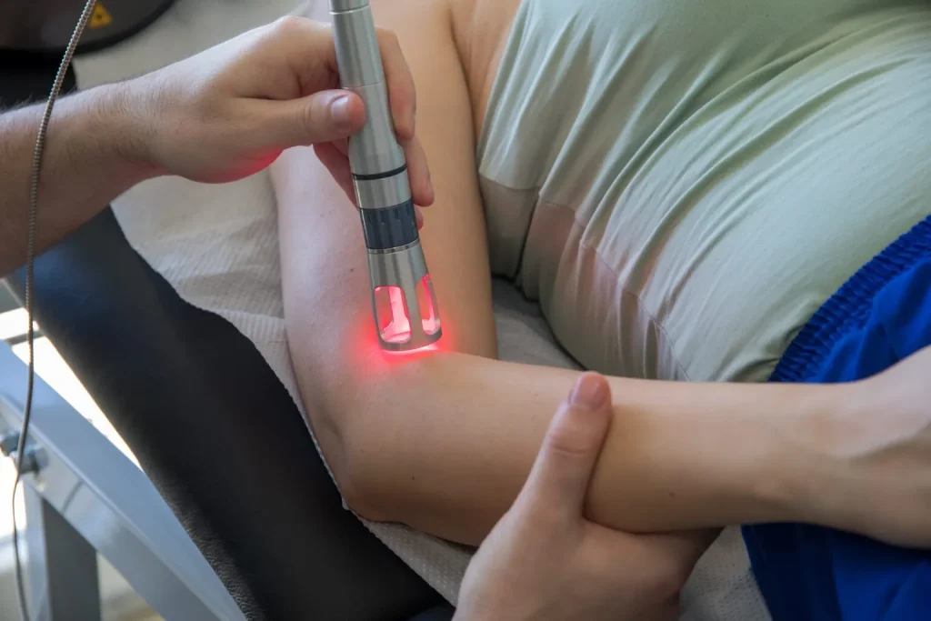 A nurse applying Laser therapy for wound care