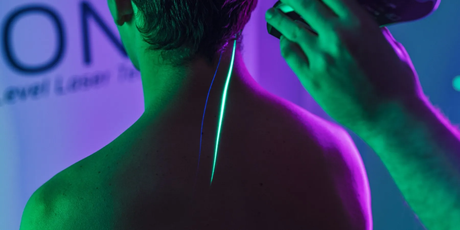 A patient resting in a treatment room during a handheld laser session
