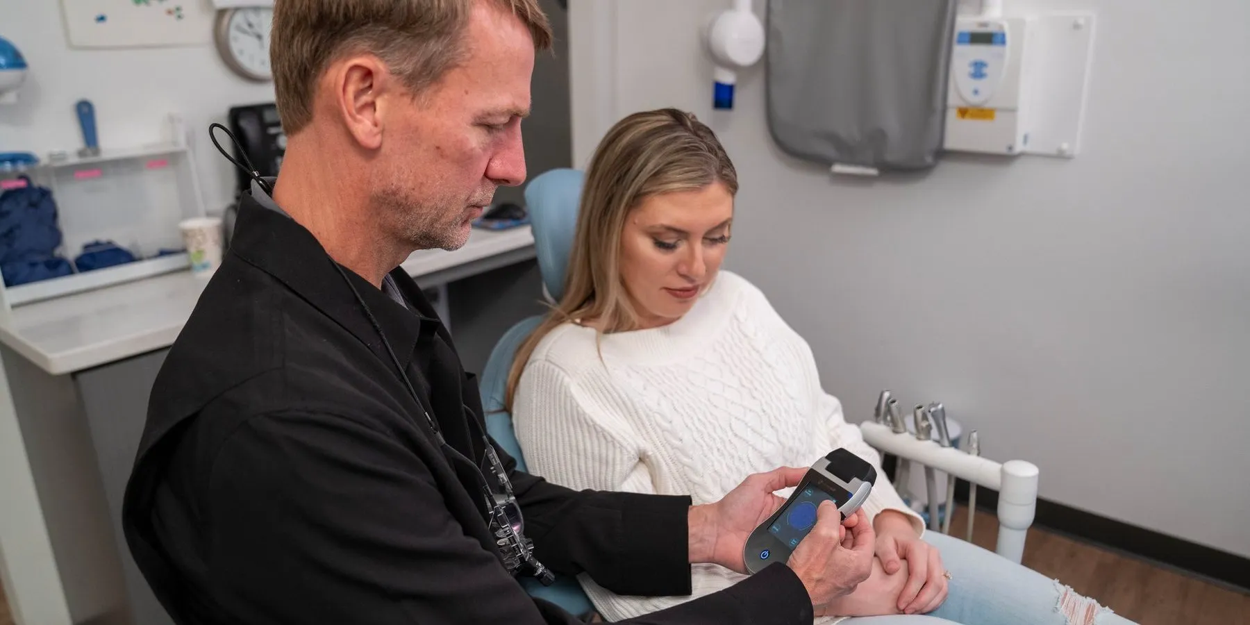 A dentist and patient in an operatory with an Erchonia handheld laser