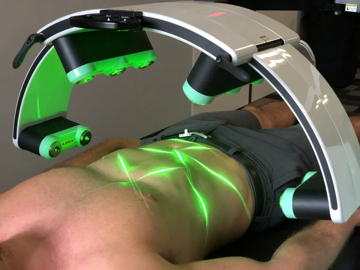A patient beneath the Emerald laser during a full-body session