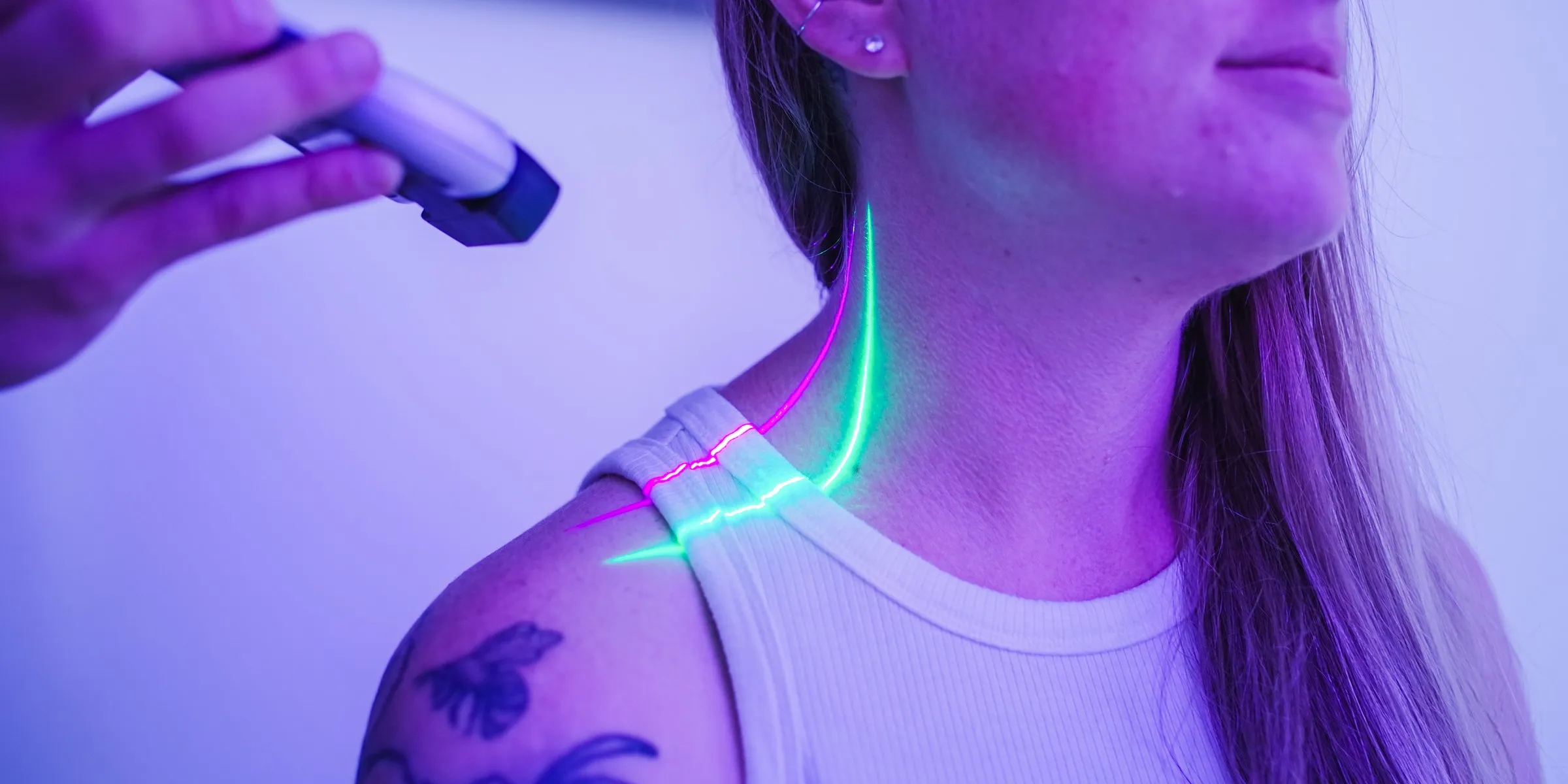 A GVL laser line on a patient’s neck in a treatment room